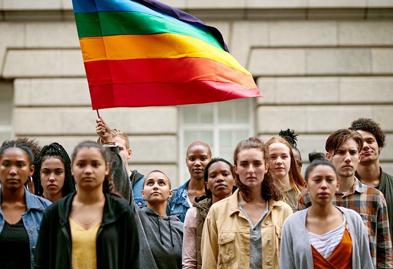 LGBTQI community with flag on city street