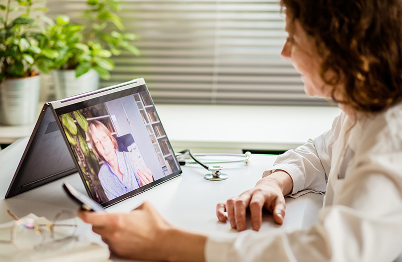 clinician meeting with elderly woman for telehealth telemedicine appointment