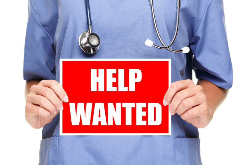 Medical doctor / nurse with a help wanted sign