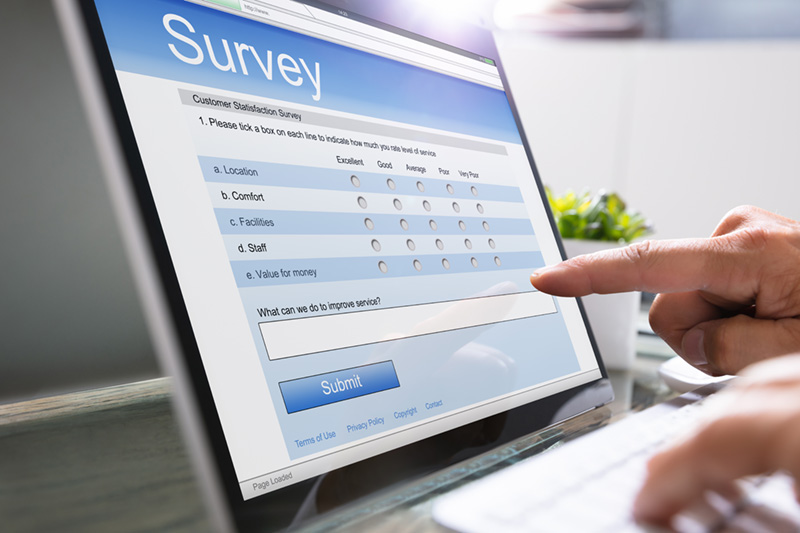 staffer using a workplace laptop taking an online survey