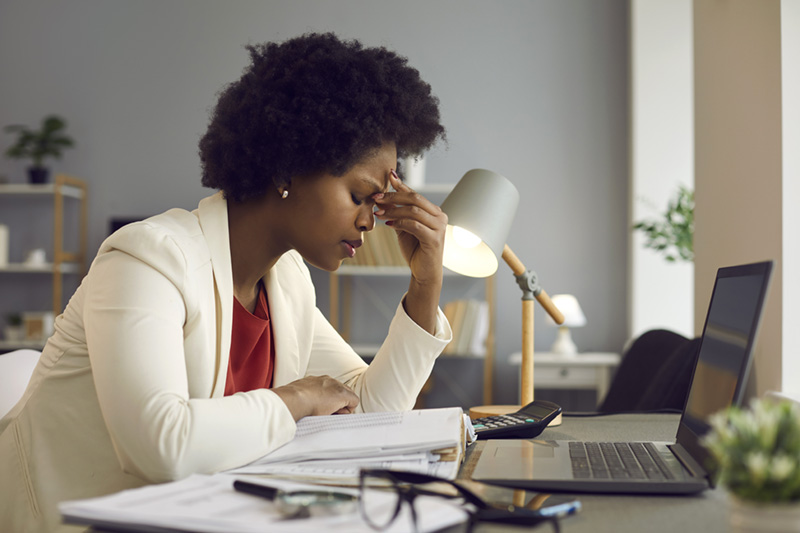 A woman feeling tired and stressed, overworked, burnout and fatigue. 