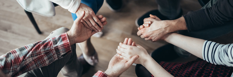 People sitting in a circle during a therapy session