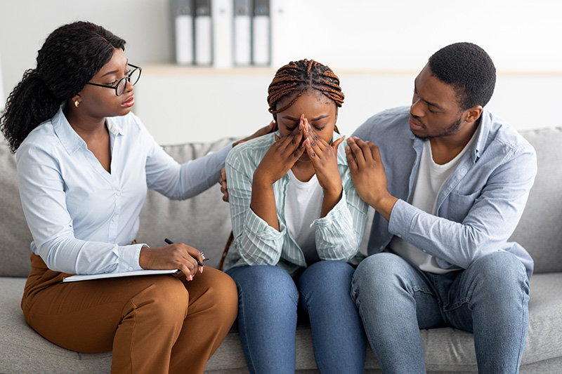 Young black couple with a family therapist