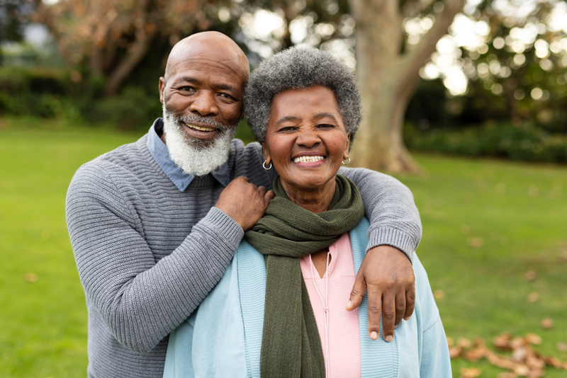 Happy black senior couple posing outdoors in autumn