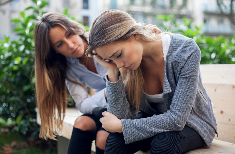 A mother consoling her depressed daughter