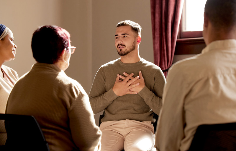 A man sharing in group therapy
