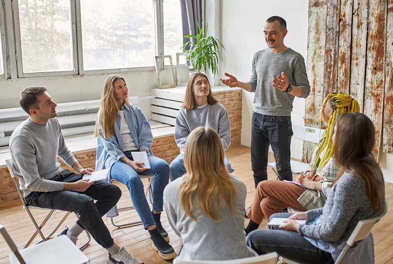 A man telling his story about his recovery to a group