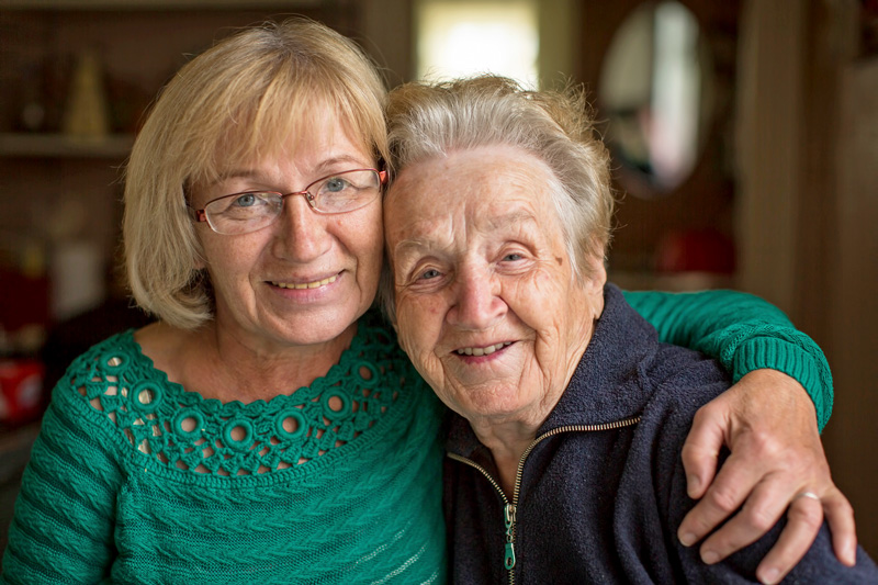 Portrait of an adult woman with her elderly mother.