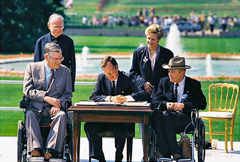 President Bush signs the Americans with Disabilities Act into law in 1990