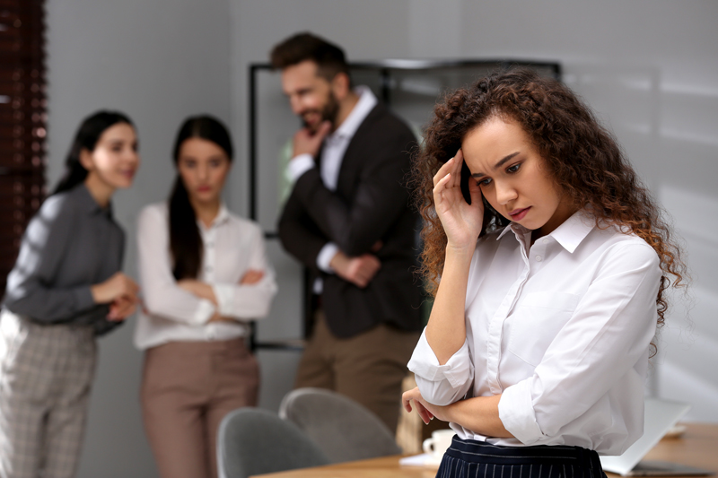 African American woman suffering from racial discrimination hazing at work