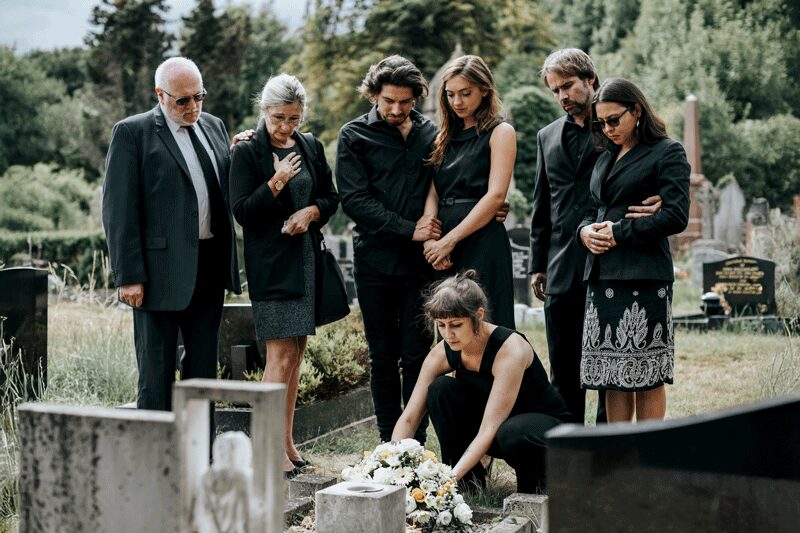 Family laying flowers on the grave