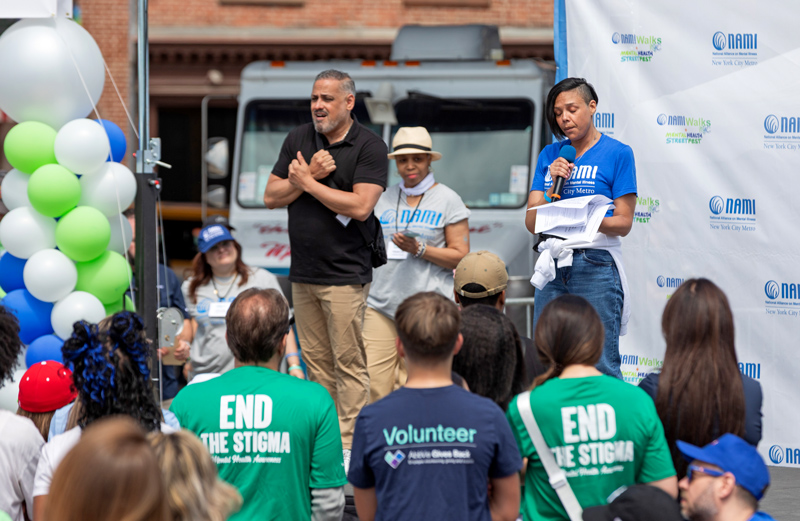 Peer-based storytelling is critical to individual recovery and creating healthier workplace environments. Centering lived experience, NAMI-NYC community member Sabrina shares about her mental health challenges as well as the loss of her son to suicide at NAMIWalks NYC + Mental Health Street Fest 2025. Credit: By Veronica Photography