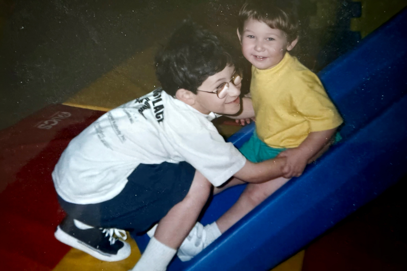 James and his brother as young children playing together before his brother became sick. James is on the right and his brother is on the left.