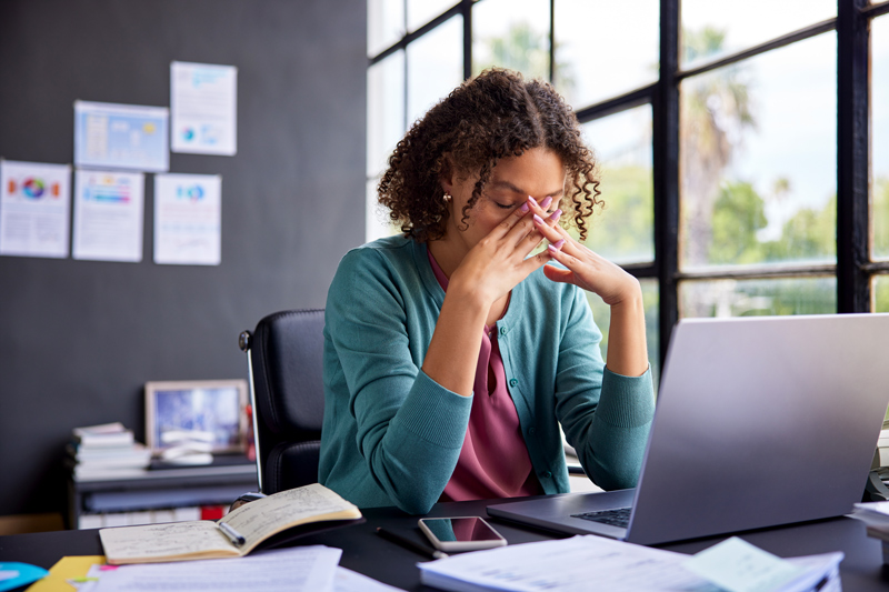 Stressed multiethnic businesswoman at work