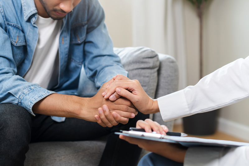 Psychology, depression. Sad asian young man consulting with psychiatrist while patient counseling mental therapy problem with doctor at clinic. Psychologist encouraging with sick mental health person