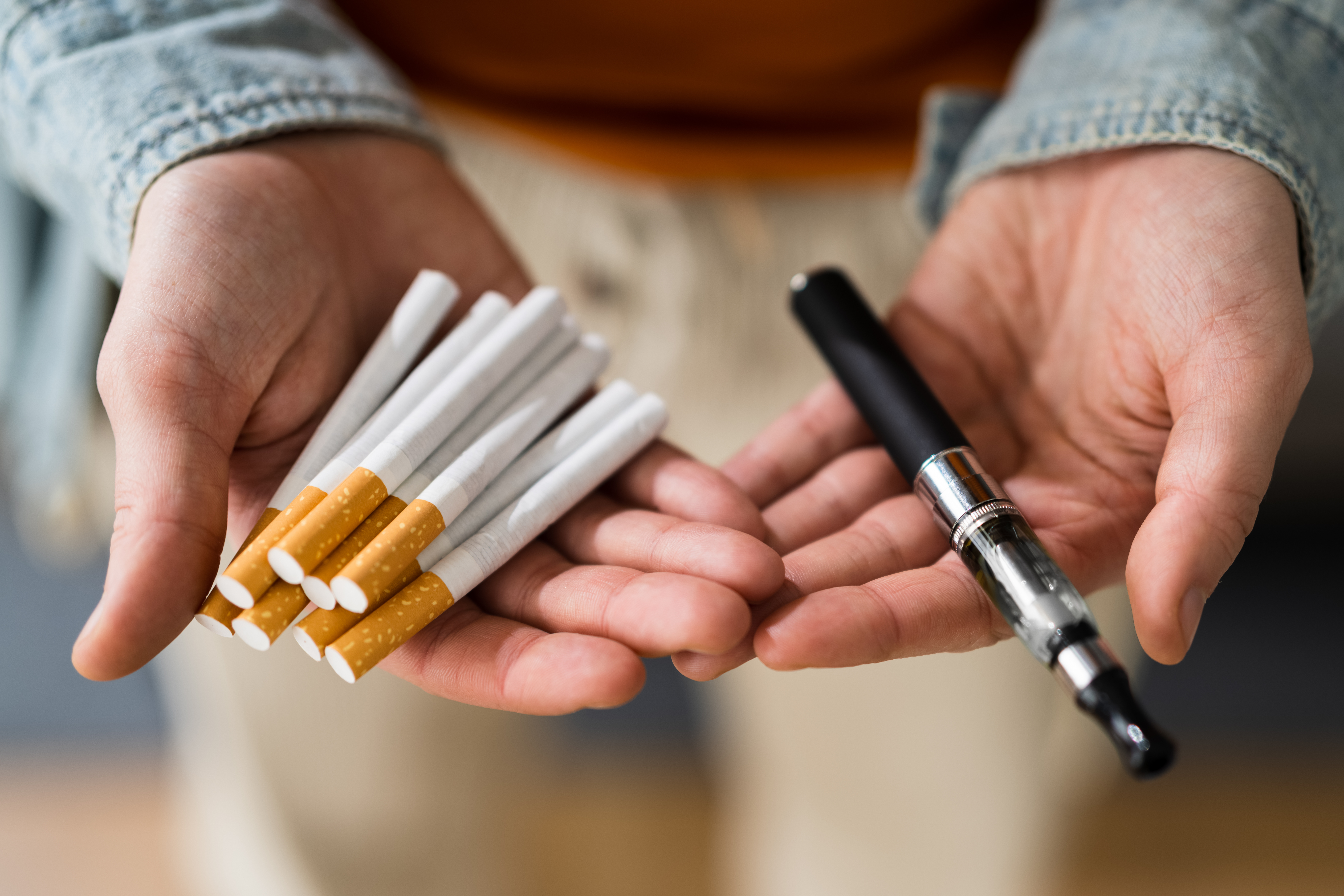 Smoking Tobacco E Cigarette. Holding Tobacco Vape